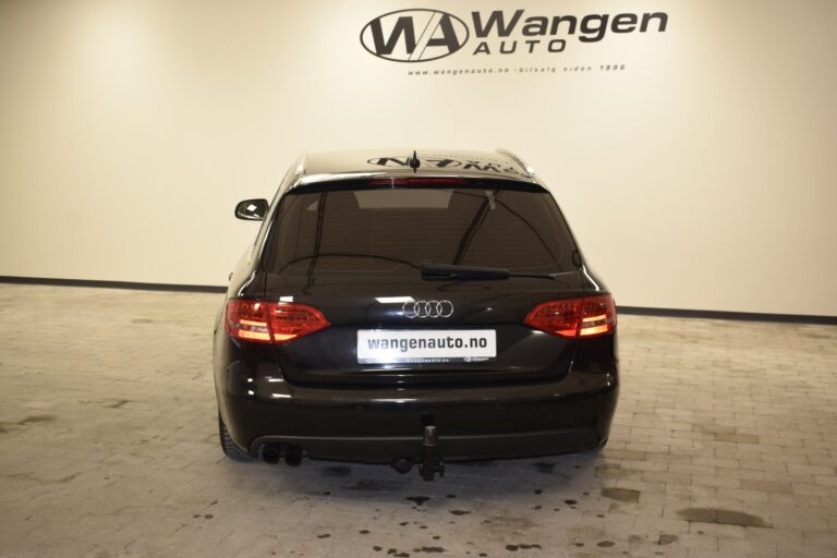 Rear view of a black Audi car parked in a showroom with a Wangen Auto sign on the wall.