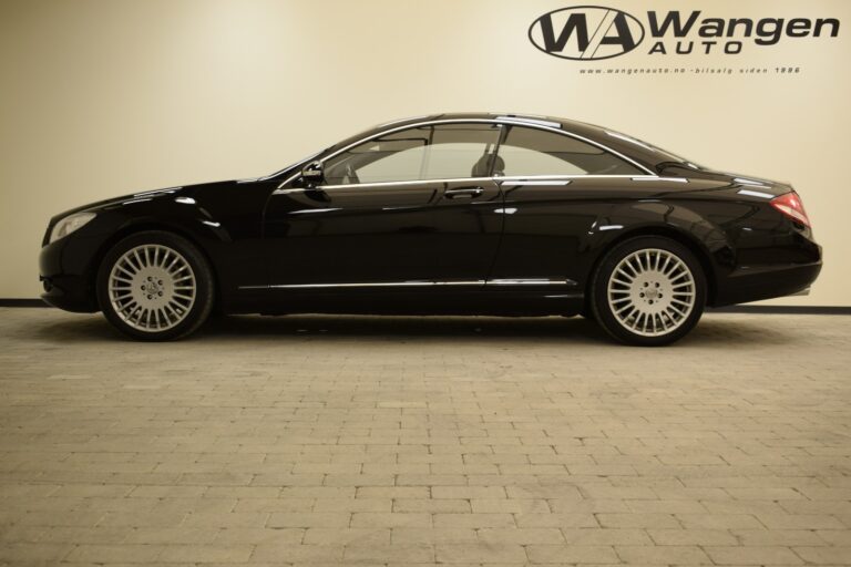 A black luxury coupe is parked indoors on a tiled floor, with the logo "Wangen Auto" displayed on the wall behind it.