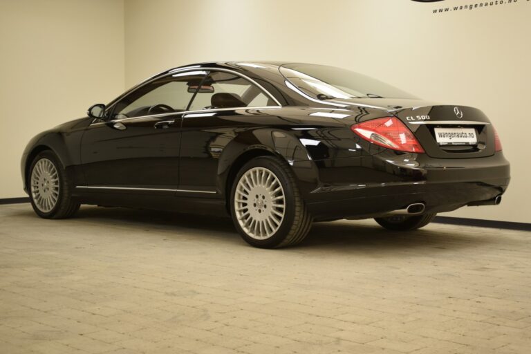 A black, two-door Mercedes-Benz CL 600 coupe is parked indoors on a light-colored tiled floor. The vehicle has chrome wheels and features a streamlined, sleek design.