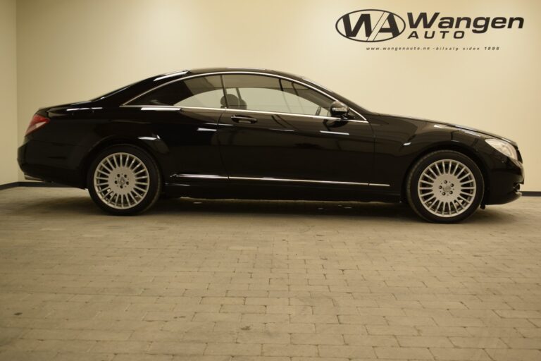 A black luxury coupe is parked indoors on a tiled floor with "Wangen Auto" branding on the wall behind it.