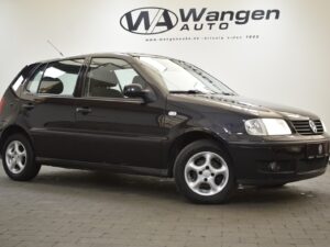 A black hatchback car is parked indoors with the logo and name "Wangen Auto" displayed on the wall behind it.