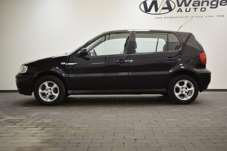 A side view of a black five-door hatchback car parked inside a showroom with the logo and name "Wange Auto" visible on the wall in the background.