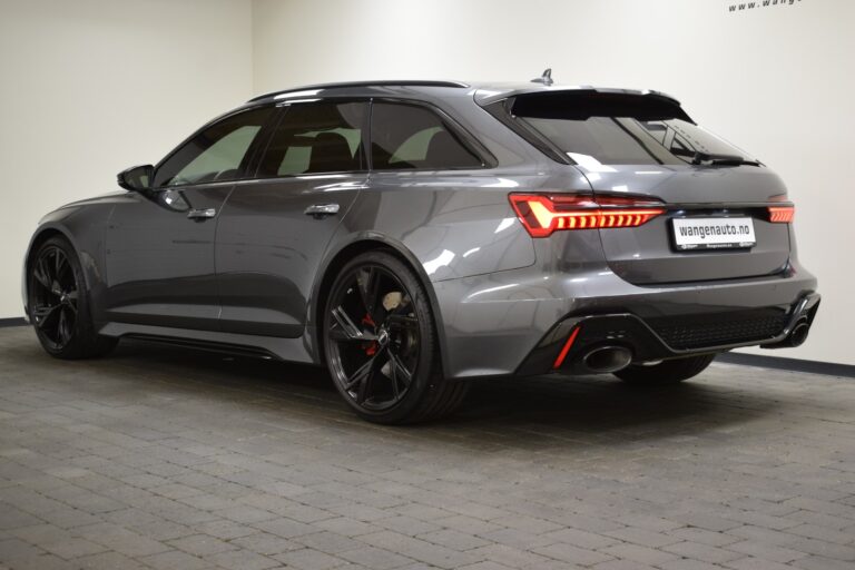 A gray, modern station wagon with sleek design and tinted windows, parked indoors on tiled flooring. The vehicle has distinct rear lights and a license plate reading "waagenauto.no".