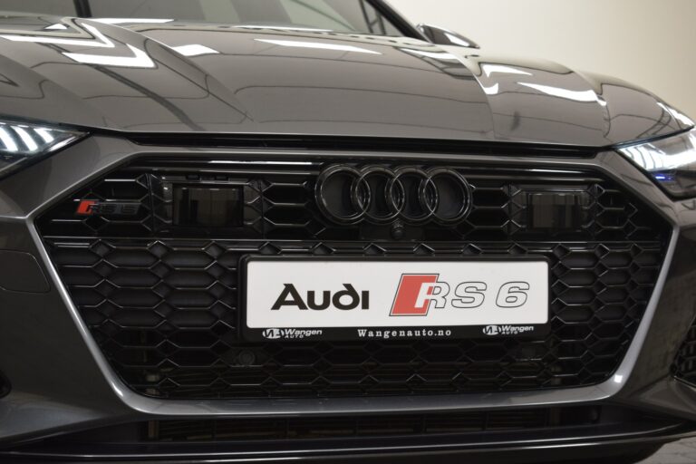 Close-up of the front grille of an Audi RS 6 with the RS 6 badge and Audi logo, displaying a license plate from Wangen Auto.