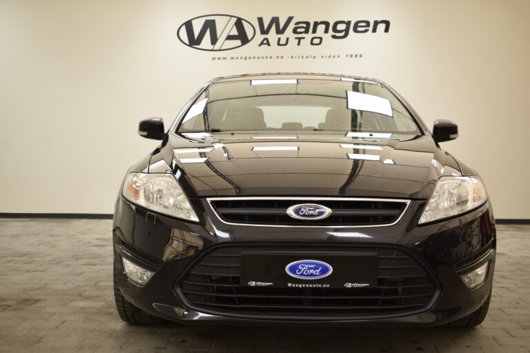 A black Ford car is shown from the front, parked indoors against a wall with the Wangen Auto logo and website.